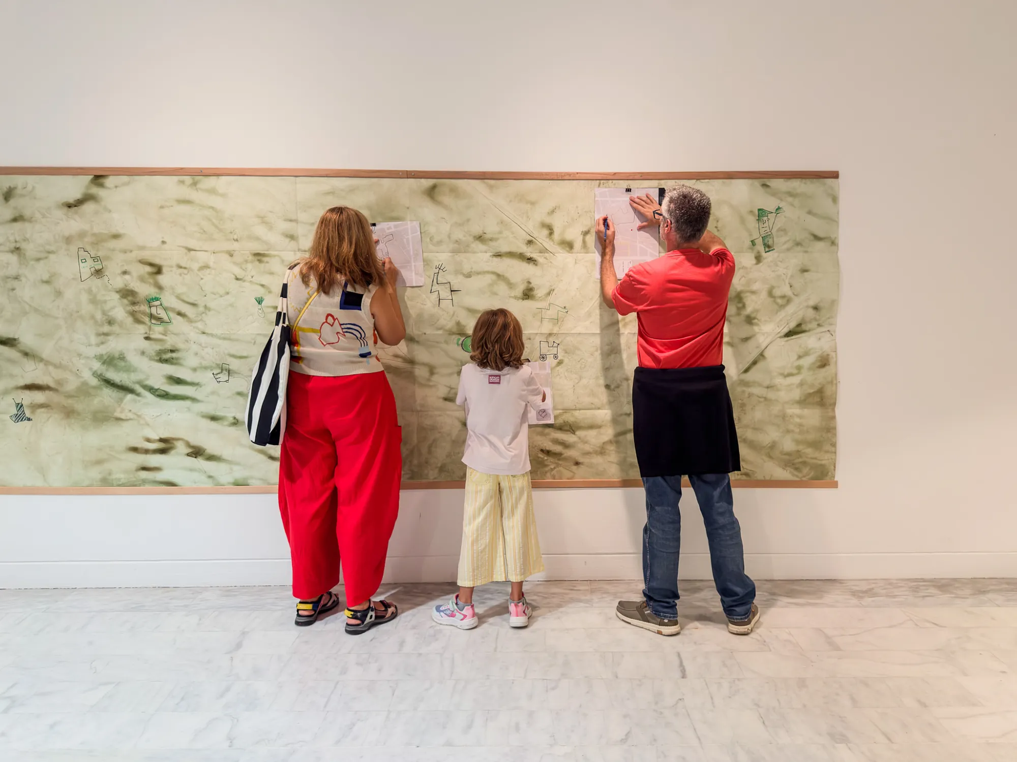 Participants inscribing their route on one of the cartographies. Drawing while Walking, Museu Picasso, Barcelona, 2026